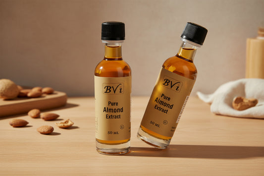 A 50 ml bottle of Pure Almond Extract by BVi with a black cap and a label that includes the brand name and product description.
